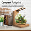 Fluval Liv compact footprint panel, the teak 1.6 gallon bowl on a desktop shelf beside books