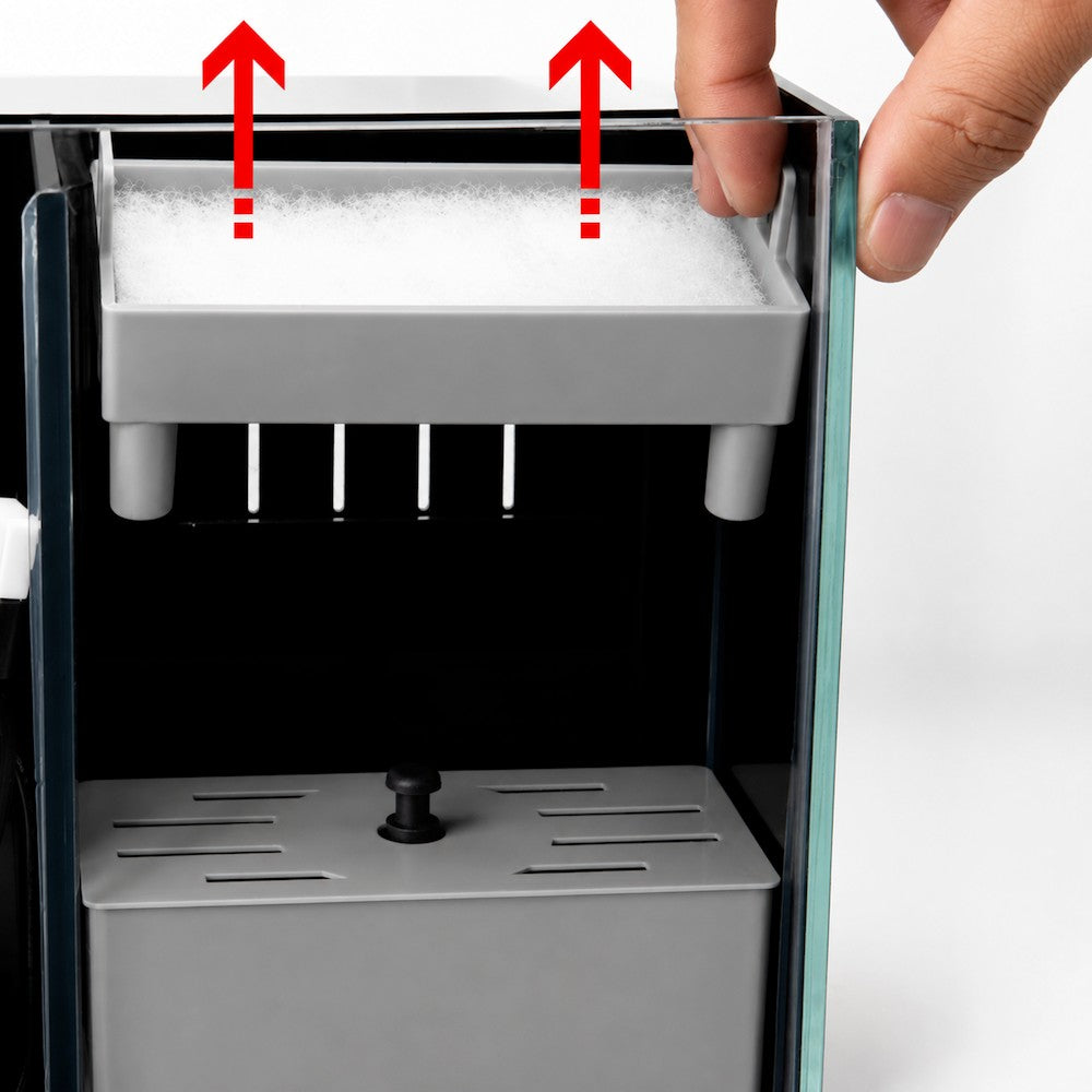 The AquaFin top filter box lifting out of the rear chamber, where the pad is changed