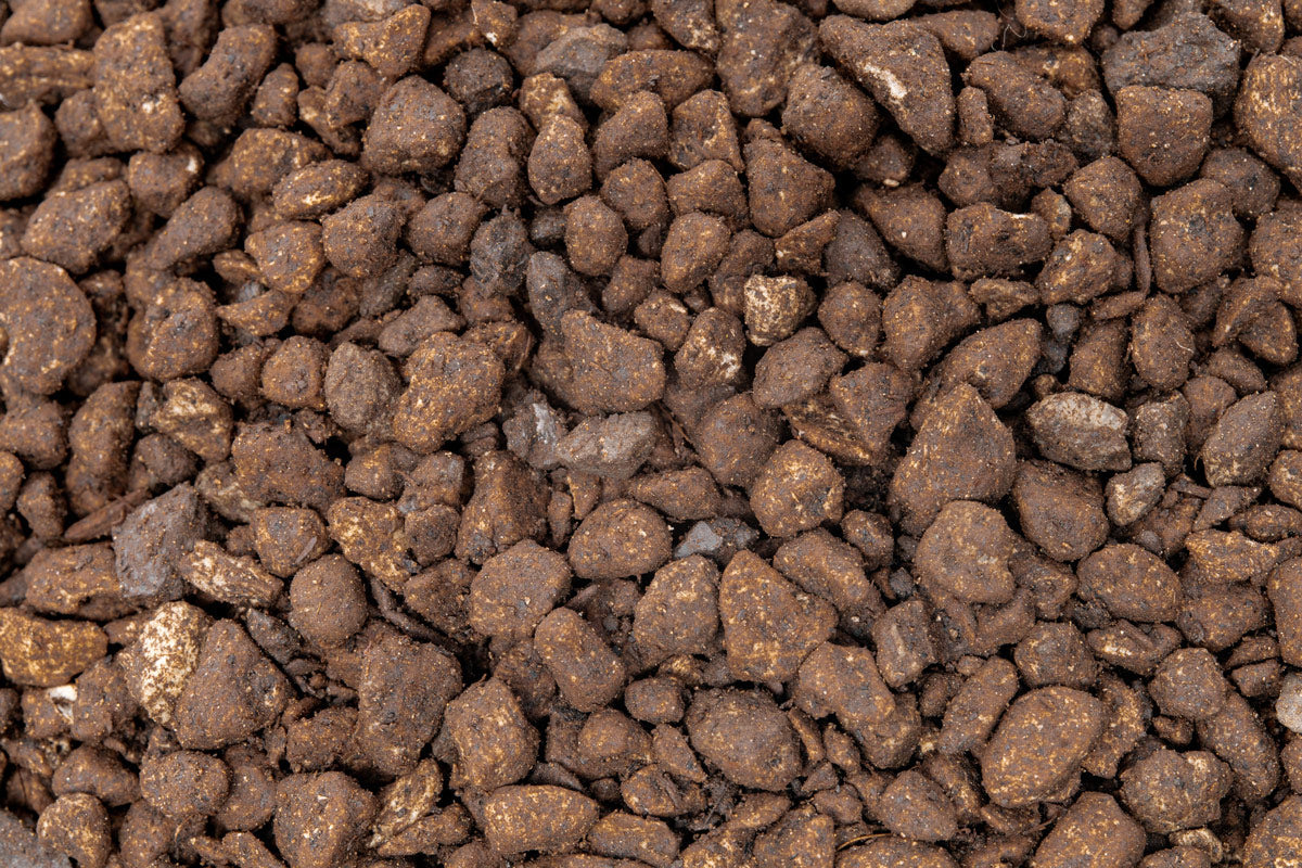 Close up of brown UNS Controbase pumice granules, 6 to 8 mm