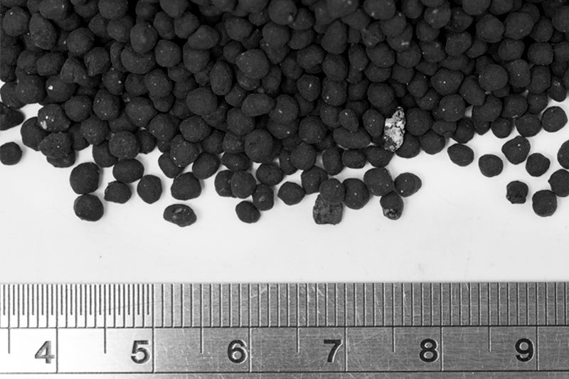 UNS Controsoil black fine granules beside a ruler, roughly 3 mm across