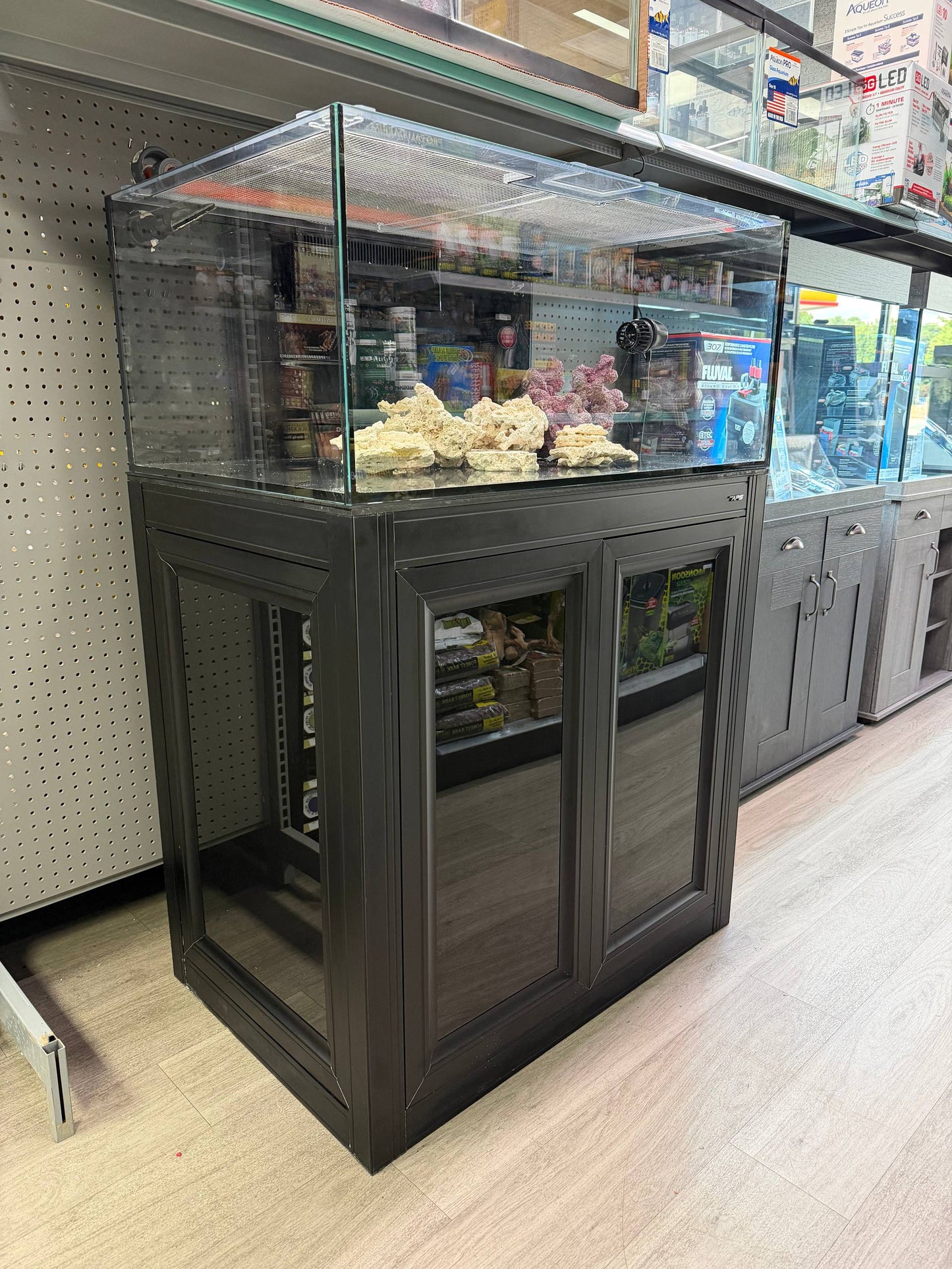 Pre-owned Fiji Cube 57 gallon shallow reef system on a black Innovative Marine aluminum stand