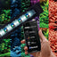 FluvalSmart app on a phone controlling the Aquasky 2.0 Bluetooth LED over a planted Flex aquarium