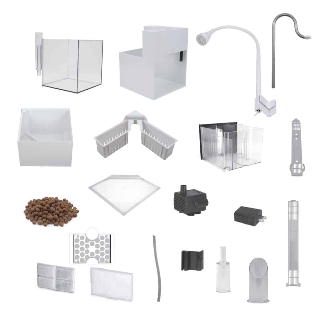 Fluval Kühl components laid out including glass tank, base, LED gooseneck lamp, plant baskets, water pump, and filter media