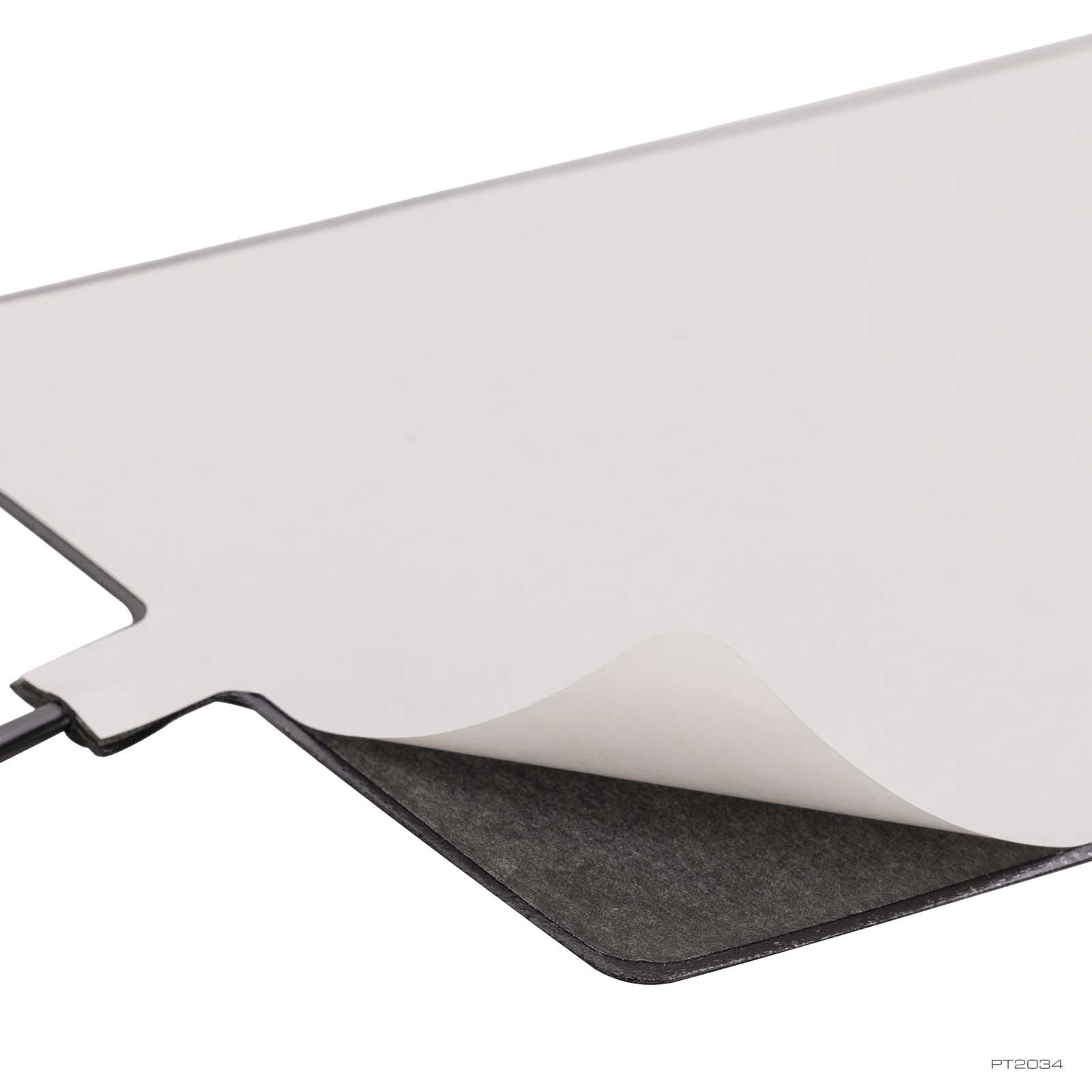 Exo Terra PTC Heat Mat with the peel-off adhesive backing lifted, showing the self-stick underside