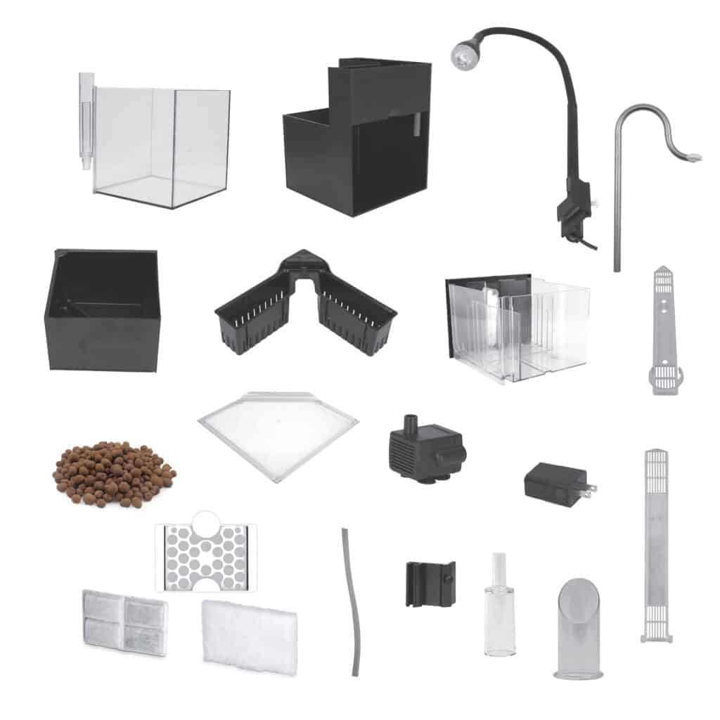 Fluval Kühl black version components laid out including glass tank, base, LED gooseneck lamp, plant baskets, water pump, and filter media